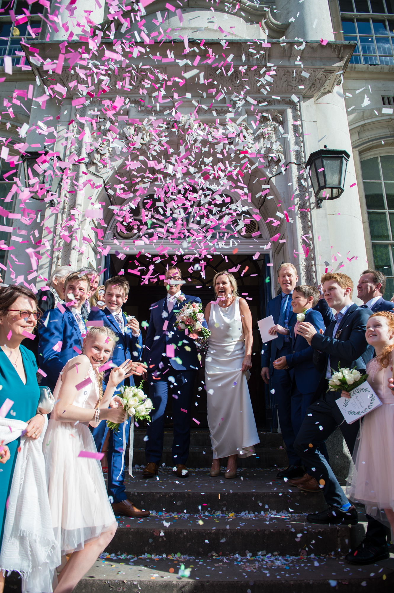 wedding party on steps at chelsea town hall during their small london city wedding